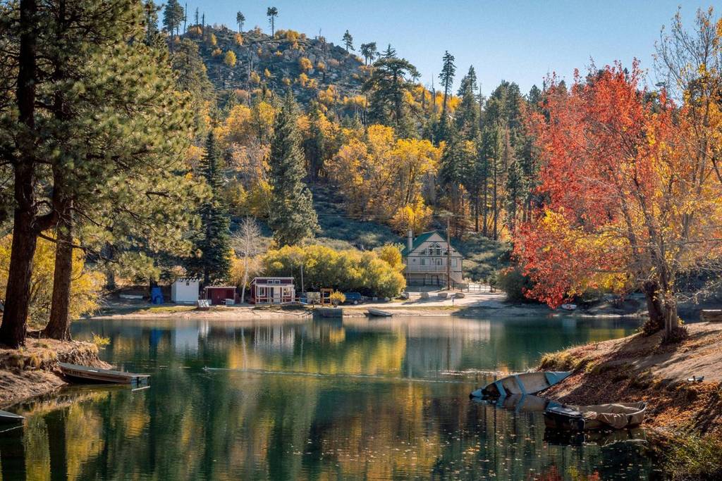 A turquoise lake surrounded by tall, snow-capped Canadian mountains.